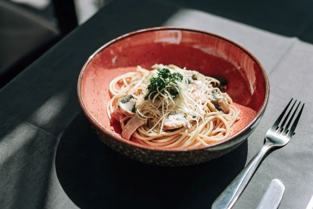 Creamy garlic Parmesan chicken pasta garnished with parsley and Parmesan cheese