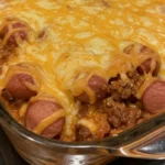 Fully loaded chili cheese dog casserole with melted cheddar