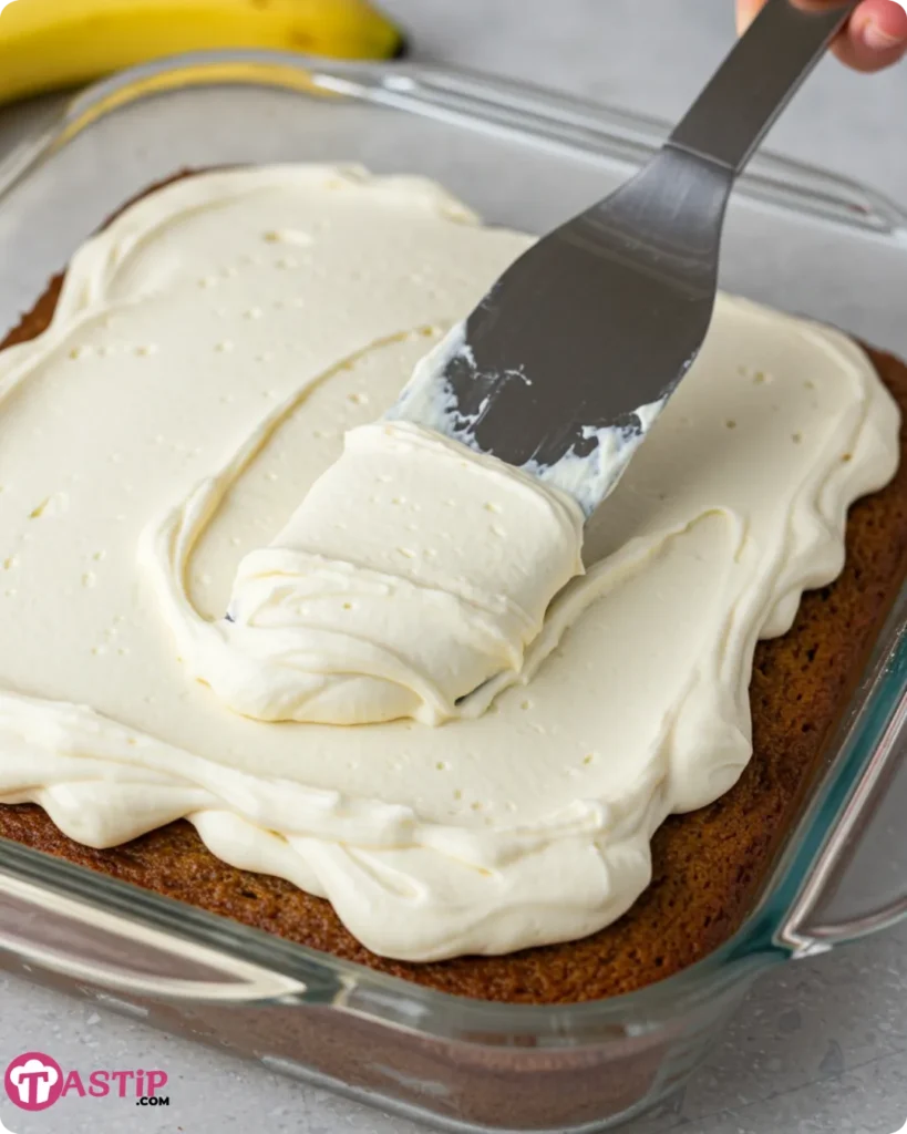 Frosting Banana Bread Cake in glass baking dish