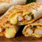 Cheesy garlic chicken wraps with melted cheese and fresh parsley