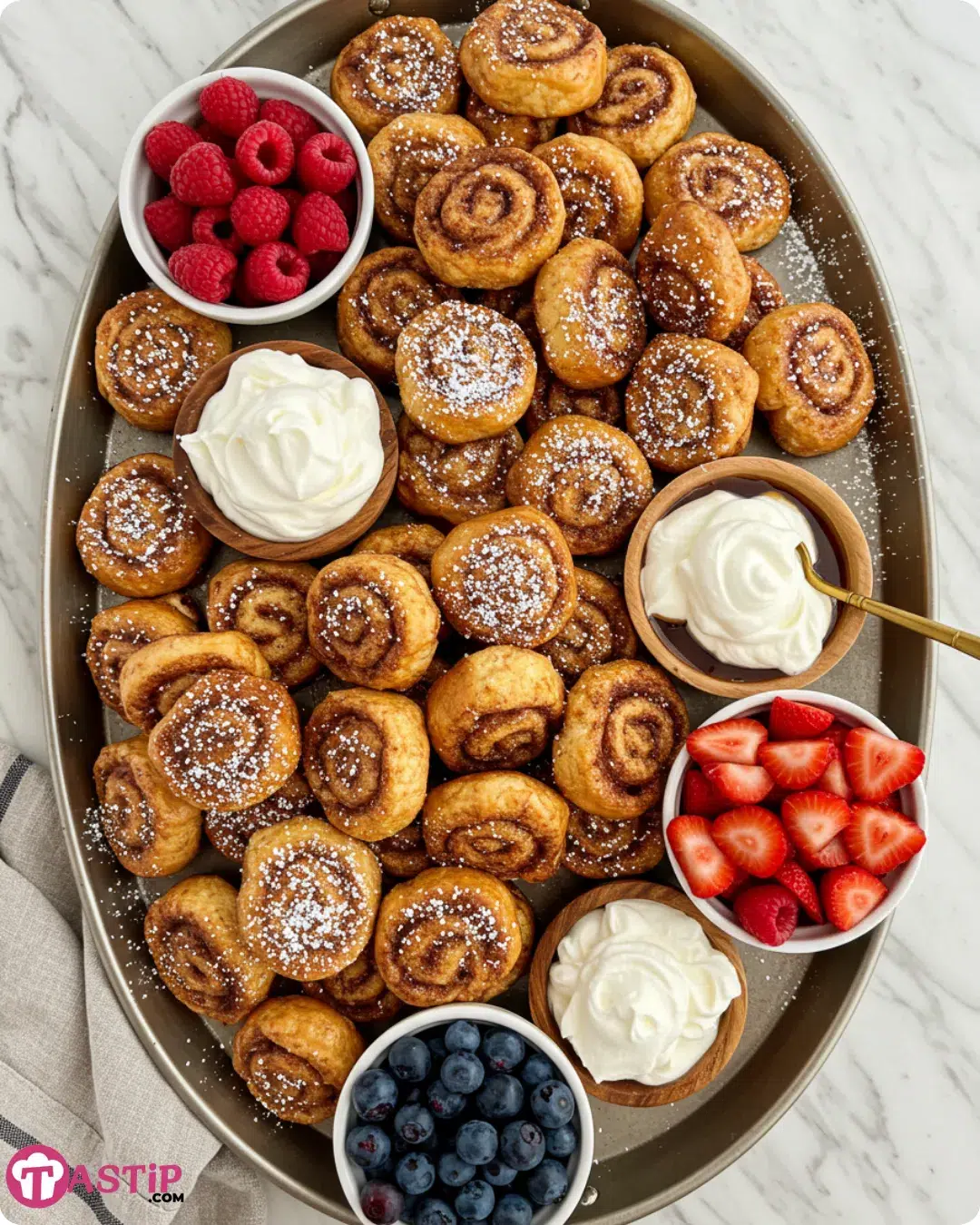 Cinnamon Roll French Toast Bites served with toppings and sides