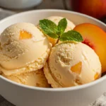 reamy Homemade Peach Ice Cream in waffle cone