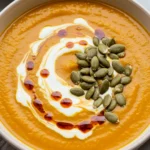 Served Gut-Healing Pumpkin Soup with pepitas and yogurt swirl