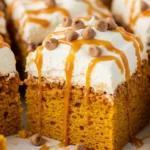 Pumpkin Poke Cake with caramel pockets and cream topping